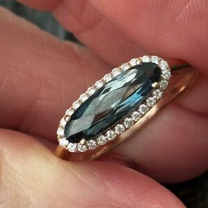 14k rose gold ring with London blue topaz and natural diamond halo.